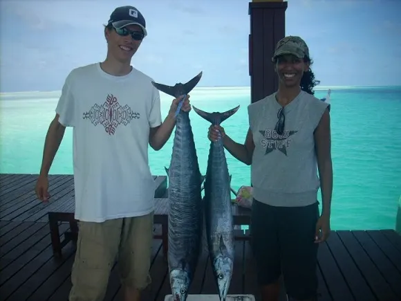 a couple fishing for wahoo in the maldives