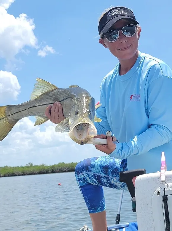 a female angler from Florida fishing for common snook