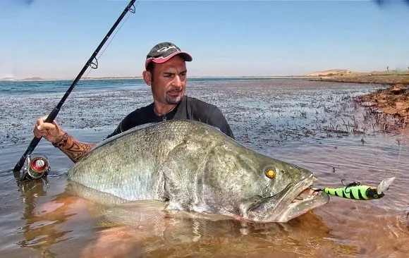 a sport angler on lake nasser with a realyl big nile perch 