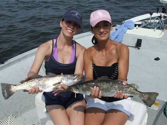 two female anglers with two nicely sized speckled trout